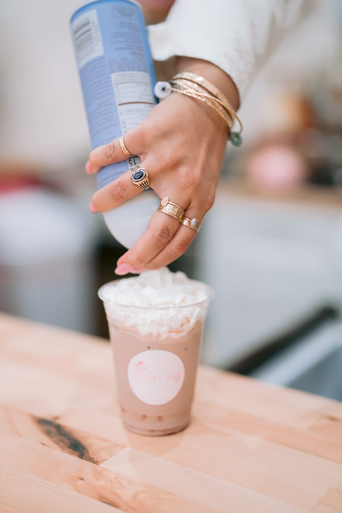 A finished drink crowned with fresh whipped cream at Sip n' Pretty.