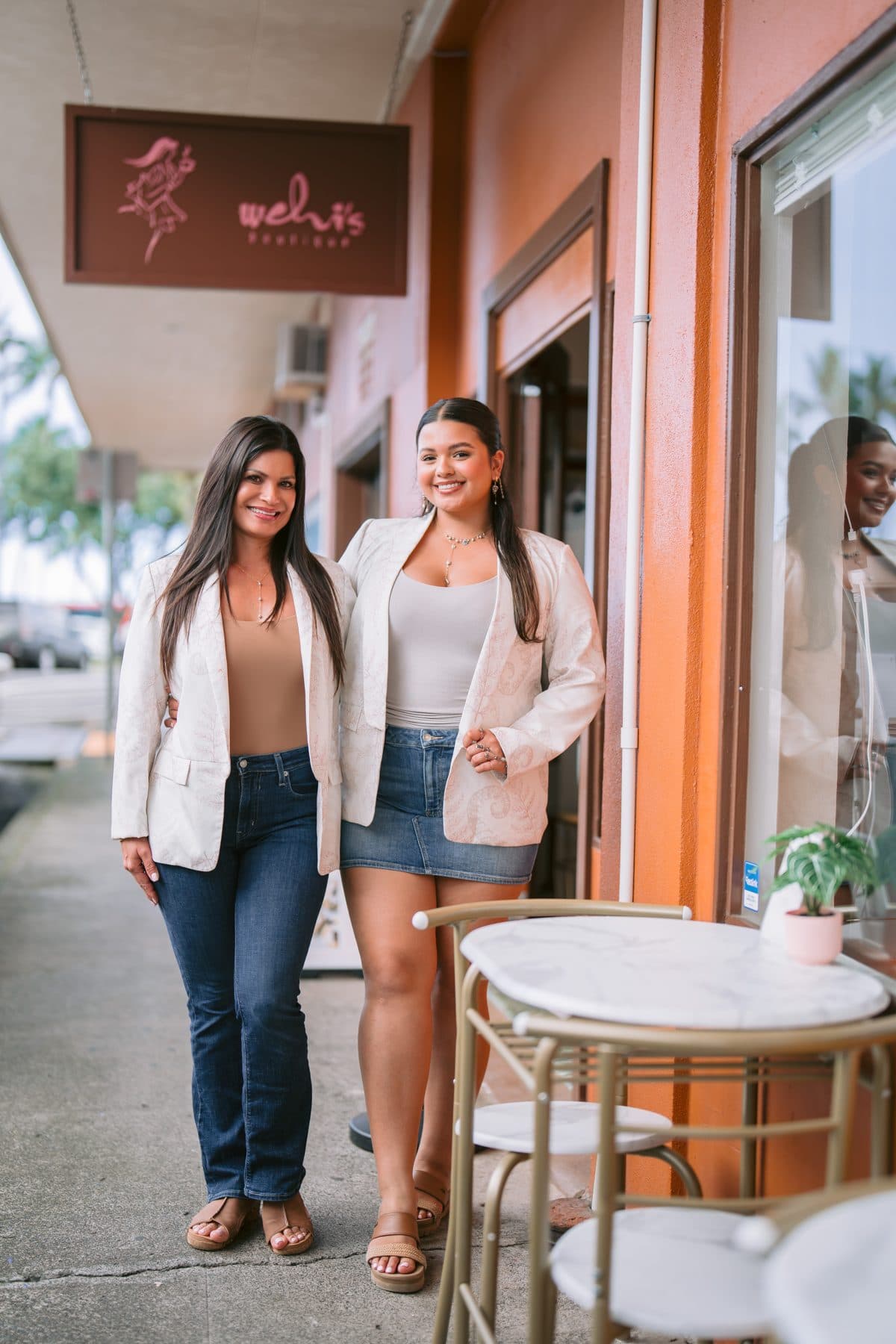 The owners outside the Wehi Boutique storefront on Furneaux Lane in Hilo, where the café lives inside.